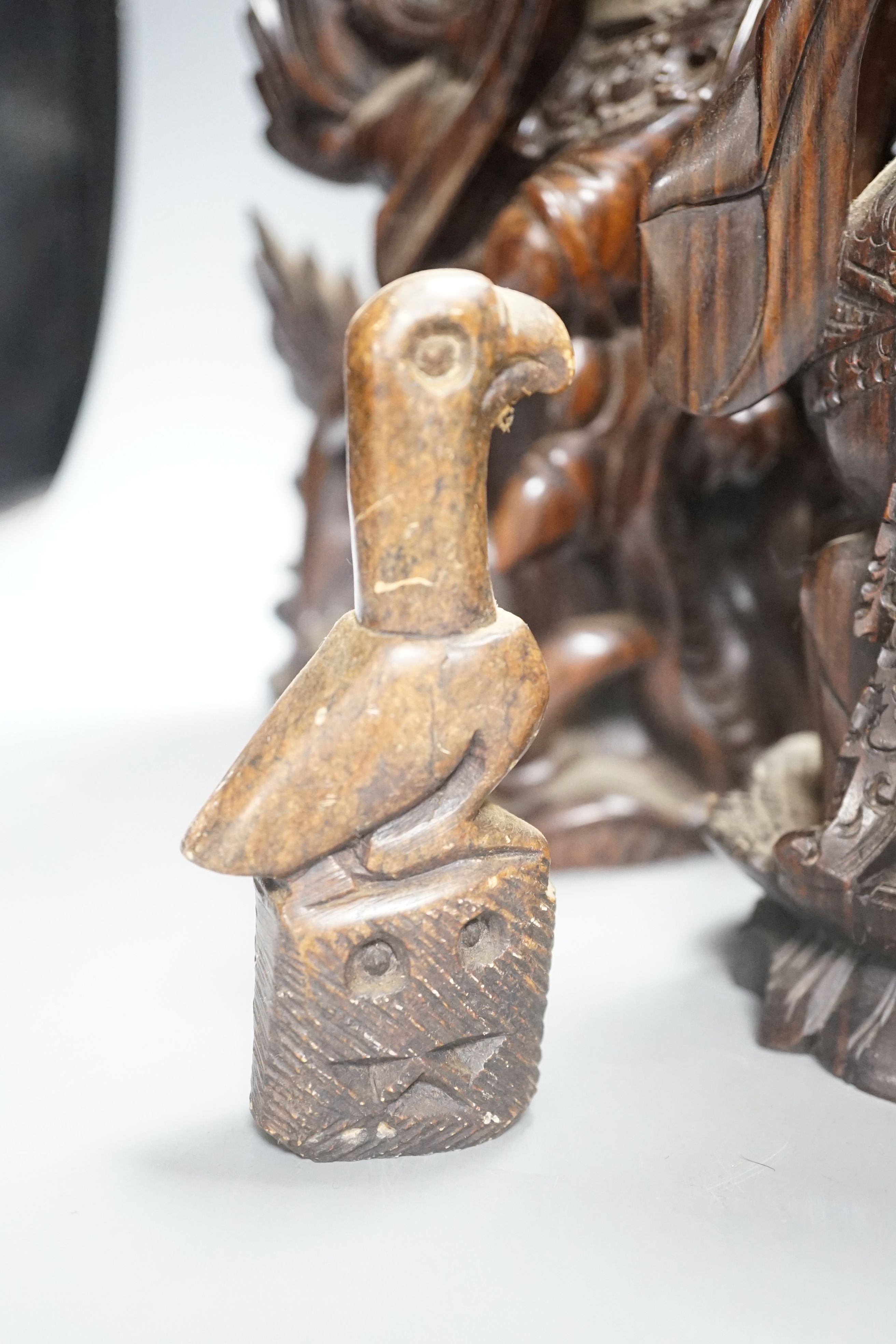 Three Balinese hardwood Macassar Ebony carvings, tallest 44.5 cm, two Chinese soapstone carvings and another